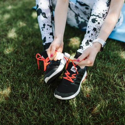 Close-up of athletic shoes on a training mat.